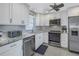 Bright kitchen with white cabinets and stainless steel appliances at 4775 Cove Cir # 904, St Petersburg, FL 33708