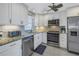 Updated kitchen, stainless steel appliances, granite countertops, white cabinets at 4775 Cove Cir # 904, St Petersburg, FL 33708