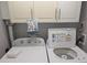White Whirlpool washer and dryer set in a compact laundry room at 4775 Cove Cir # 904, St Petersburg, FL 33708