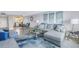 Open living space featuring a sectional sofa and adjacent kitchen at 4775 Cove Cir # 904, St Petersburg, FL 33708