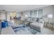 Living room with sectional sofa and view of kitchen and dining area at 4775 Cove Cir # 904, St Petersburg, FL 33708