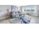 Living room with gray sectional sofa and blue accent chair at 4775 Cove Cir # 904, St Petersburg, FL 33708