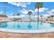Community pool with surrounding patio furniture at 4775 Cove Cir # 904, St Petersburg, FL 33708