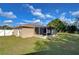 Backyard view showcasing the screened porch and grassy area at 5624 Mccoy Ct, Zephyrhills, FL 33542