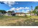 Back of house and surrounding green yard featuring a fenced perimeter at 5624 Mccoy Ct, Zephyrhills, FL 33542