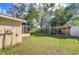 Green backyard featuring a patio and storage area at 5624 Mccoy Ct, Zephyrhills, FL 33542