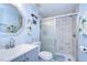 Modern bathroom with blue walls, subway tile shower, and vanity at 5624 Mccoy Ct, Zephyrhills, FL 33542