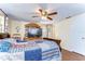 Comfortable bedroom with a large TV and neutral decor at 5624 Mccoy Ct, Zephyrhills, FL 33542