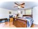 Bedroom with wood-look floors, a ceiling fan, and a workspace at 5624 Mccoy Ct, Zephyrhills, FL 33542