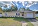 Single-story home with attached garage and landscaped front yard at 5624 Mccoy Ct, Zephyrhills, FL 33542