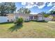 Front yard with a driveway, landscaping, and attached garage at 5624 Mccoy Ct, Zephyrhills, FL 33542