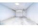 One-car garage with white walls and garage door at 5624 Mccoy Ct, Zephyrhills, FL 33542