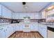 Kitchen with white cabinets, laminate countertops, and modern appliances at 5624 Mccoy Ct, Zephyrhills, FL 33542