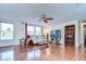 Living area with wood-look tile floors, ceiling fan, and natural light at 5624 Mccoy Ct, Zephyrhills, FL 33542