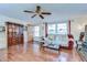 Living room with ceiling fan, wood-look tile floors, and lots of natural light at 5624 Mccoy Ct, Zephyrhills, FL 33542