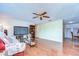 Living room featuring wood-look tile flooring, a ceiling fan, and an open layout at 5624 Mccoy Ct, Zephyrhills, FL 33542