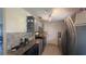 Updated kitchen with stainless steel appliances, granite counters, gray cabinets, and tile flooring at 6425 Rosewood Dr, Tampa, FL 33615