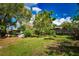 Large backyard featuring mature trees, and a wood fence at 9567 85Th St, Seminole, FL 33777