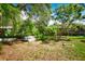 This backyard has a mix of open grassy areas and lush vegetation creating a private outdoor space at 9567 85Th St, Seminole, FL 33777