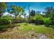 Secluded backyard boasts lush trees and green grass perfect for outdoor activities at 9567 85Th St, Seminole, FL 33777