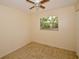 Minimalist bedroom with neutral walls, ceiling fan and a window offering natural light with tile flooring at 9567 85Th St, Seminole, FL 33777
