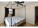Bedroom features a unique canopy bed, ceiling fan and window dressed in dark curtains at 9567 85Th St, Seminole, FL 33777