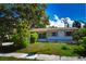 Charming home with a well-manicured front lawn and lush greenery at 9567 85Th St, Seminole, FL 33777