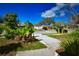 View of front yard featuring trees, landscaping and neighborhood street at 9567 85Th St, Seminole, FL 33777