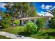 Charming single-story home featuring lush landscaping and a well-maintained front yard at 9567 85Th St, Seminole, FL 33777