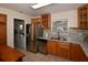 Charming kitchen with stainless steel appliances, wooden cabinetry, granite countertops, and access to laundry room at 9567 85Th St, Seminole, FL 33777