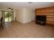 Spacious living room with tile floors, wood accent wall, and sliding glass doors to the backyard at 9567 85Th St, Seminole, FL 33777