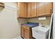 Laundry room with utility sink, wood cabinets, and wire storage racks at 106 Rosana Dr, Brandon, FL 33511