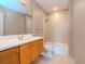 Bathroom with tiled shower, white toilet, and wood vanity at 1120 E Kennedy Blvd # 927, Tampa, FL 33602
