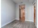 Empty bedroom with gray walls and wood-look flooring, view of bathroom and closet at 1120 E Kennedy Blvd # 927, Tampa, FL 33602