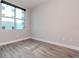 Empty bedroom with large window and wood-style flooring at 1120 E Kennedy Blvd # 927, Tampa, FL 33602
