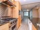 Modern kitchen with stainless steel appliances, wood cabinets, and granite countertops at 1120 E Kennedy Blvd # 927, Tampa, FL 33602