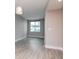Empty living room with wood-style flooring, large window, and neutral gray walls at 1120 E Kennedy Blvd # 927, Tampa, FL 33602