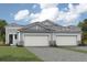 Charming two-story home with a welcoming front entrance and attached garage at 11860 Boundless Ter, Venice, FL 34293