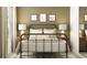 Inviting bedroom with simple decor, a metal bed frame, and soft lighting at 12430 Sweet Angel Aura Way, Parrish, FL 34219