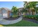 Inviting front entrance with double doors and lush tropical landscaping at 14426 Mark Dr, Largo, FL 33774