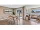 Dining area with a wooden table and chairs, adjacent to the living area with sliding glass doors at 1726 Tahitian Sunrise Dr, Plant City, FL 33565