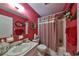 Red-themed bathroom with a tub and shower at 1901 Canterbury Ln # 19, Sun City Center, FL 33573