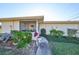 Charming condo exterior featuring a screened porch and well-maintained landscaping at 1901 Canterbury Ln # 19, Sun City Center, FL 33573