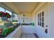 Inviting front porch with potted plants and wind chimes at 1901 Canterbury Ln # 19, Sun City Center, FL 33573