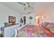 Main bedroom with a comfortable bed, dresser, and ceiling fan at 1901 Canterbury Ln # 19, Sun City Center, FL 33573