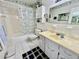 Bright bathroom featuring a vanity with plenty of counter space, a bath and shower at 2403 Finlandia Ln # 57, Clearwater, FL 33763