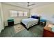 Modest bedroom featuring a bed, a dresser and a large window at 2403 Finlandia Ln # 57, Clearwater, FL 33763