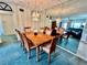 Elegant dining room with a decorative chandelier and seating for six at 2403 Finlandia Ln # 57, Clearwater, FL 33763