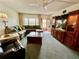 Cozy living room showcasing a large sectional sofa, wood furnishings, and bright natural light at 2403 Finlandia Ln # 57, Clearwater, FL 33763