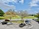 View of the parking lot with nearby golf course and abundant parking spaces at 2403 Finlandia Ln # 57, Clearwater, FL 33763